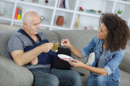 live-in caregiver feeding elderly